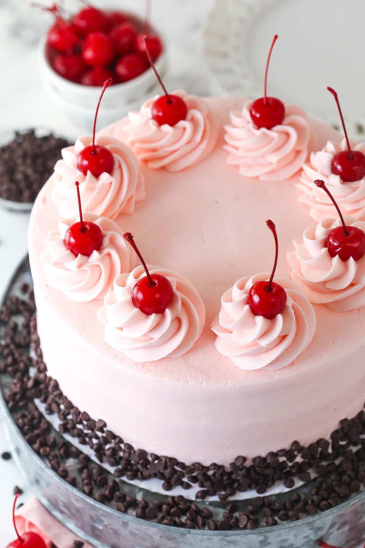 This cherry chocolate chip cake is moist, tender, and full of cherry and chocolate flavor in every single bite. Overhead view of a cherry chocolate chip cake
