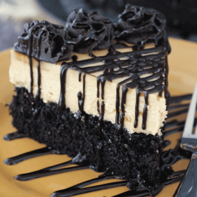 Peanut Butter Truffle Chocolate Cake slice on gold plate close up