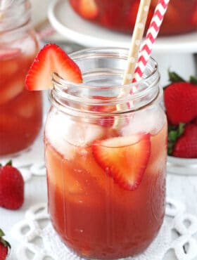 Close-up of a Mason Jar of Strawberry Vanilla Sweet Tea with two straws