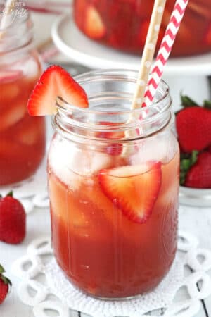 Close-up of a Mason Jar of Strawberry Vanilla Sweet Tea with two straws