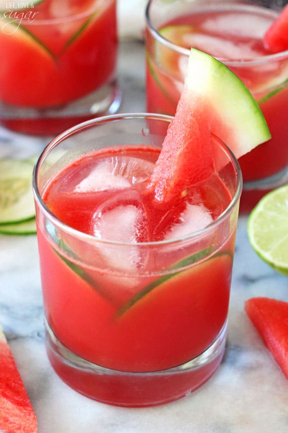 Watermelon Elderflower Cocktail in a rocks glass with watermelon and cucumber garnish