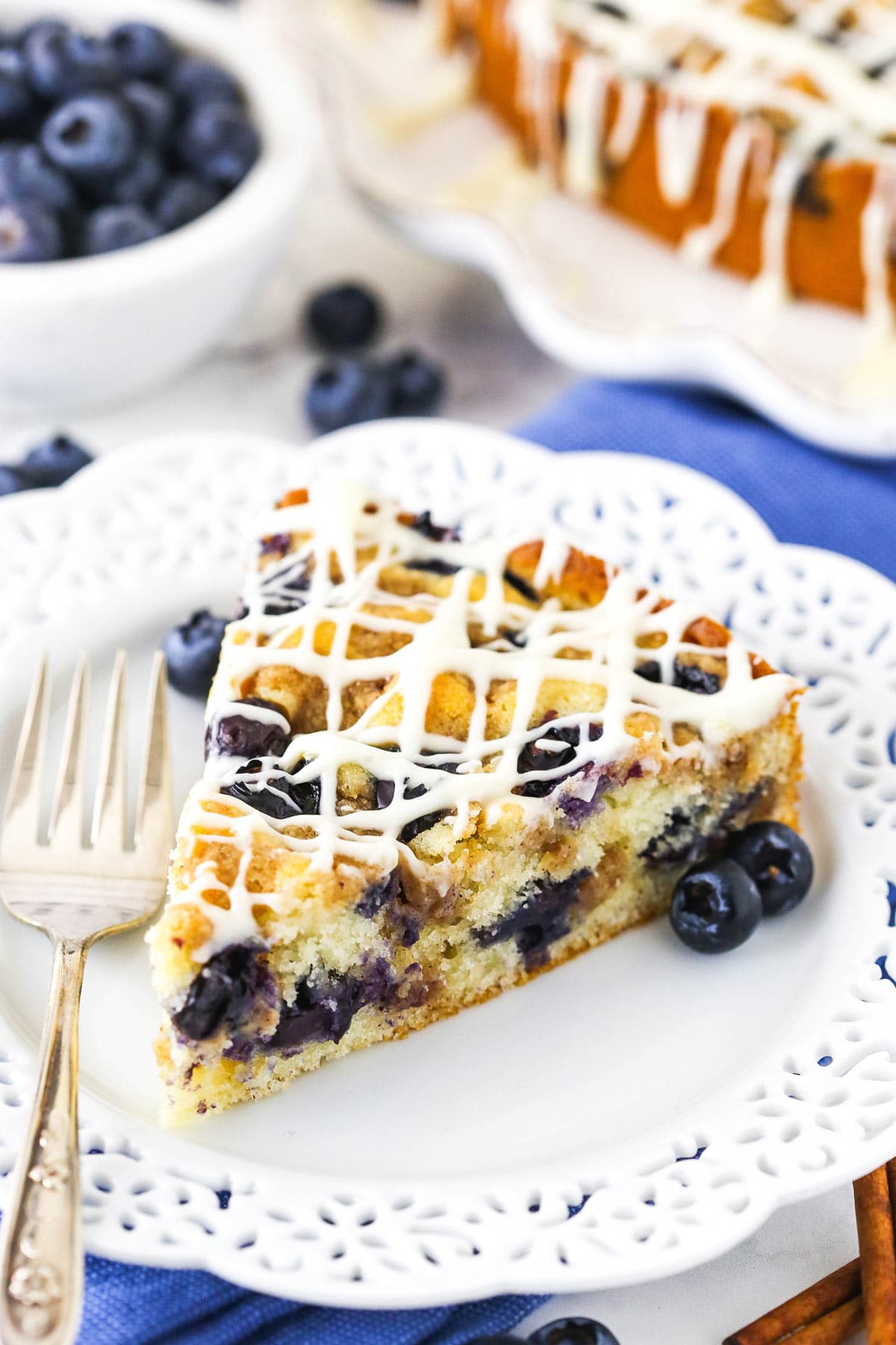 close up of slice of Blueberry Streusel Coffee Cake on white plate
