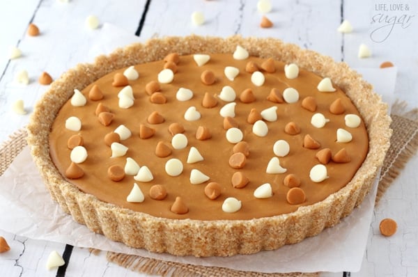 A whole White Chocolate Butterscotch Tart sitting on white paper