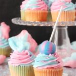 Cotton Candy Cupcakes with cotton candy on top and lollipop on top