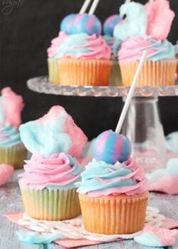 Cotton Candy Cupcakes with cotton candy on top and lollipop on top