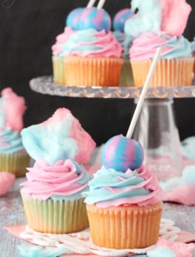 Cotton Candy Cupcakes with cotton candy on top and lollipop on top