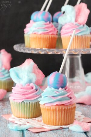 Cotton Candy Cupcakes with cotton candy on top and lollipop on top