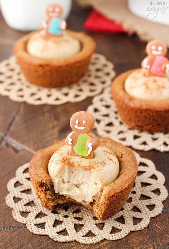 Gingerbread Cheesecake Cookie Cups topped with mini gingerbread cookies with a bite out of one
