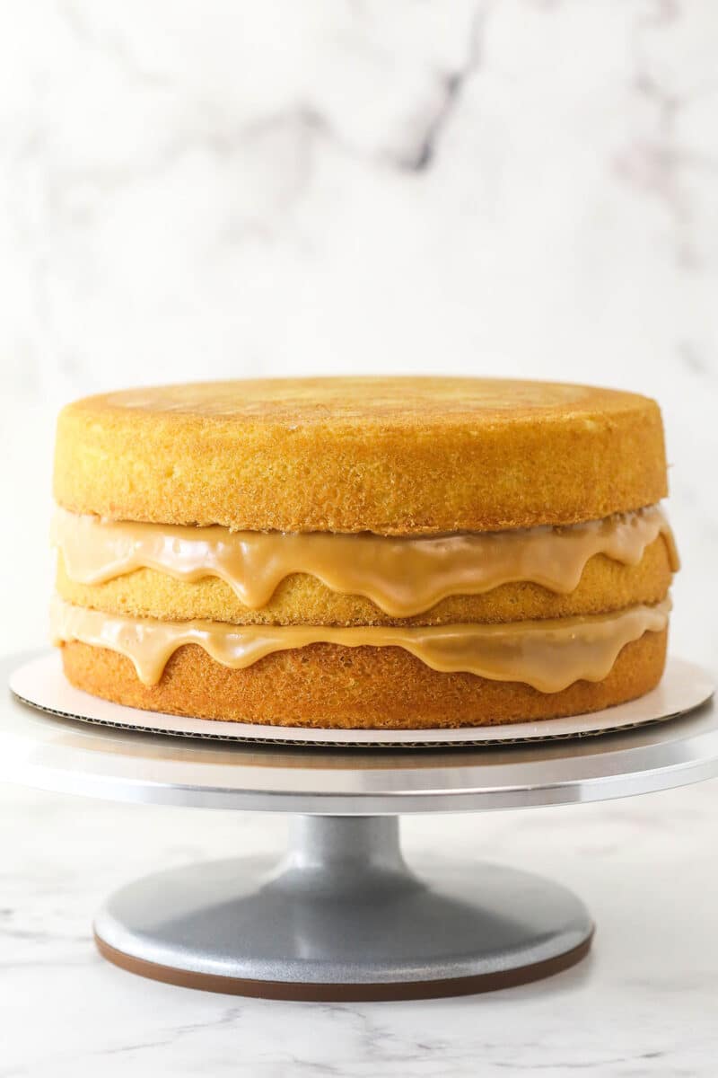 caramel cake layered with caramel dripping down the sides