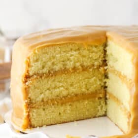caramel cake with a couple slices cut out