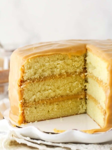 caramel cake with a couple slices cut out