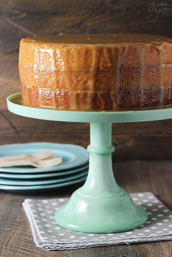 Homemade cake drenched in caramel on a cake stand