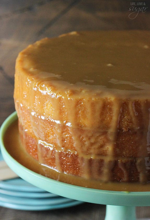 Moist cake drenched in caramel sauce on a cake stand