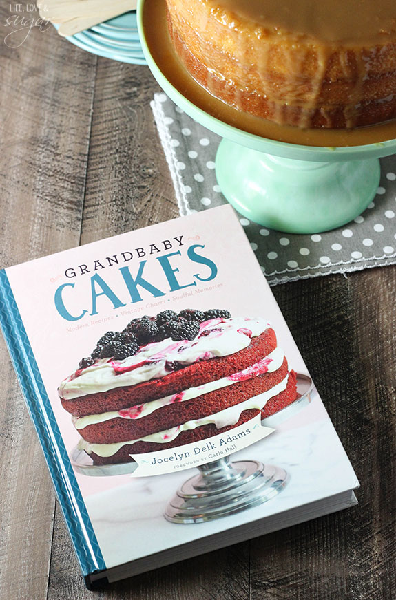 The book "Grandbaby Cakes" next to a cake on a stand.