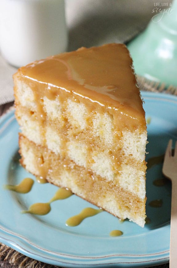 Fluffy slice of caramel cake on a blue plate.