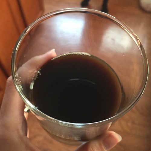 Packets in the Glass Mixed with Water to Create a Dark Colored Liquid