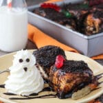 Two Chocolate Sticky Buns with gummy worms and a whipped cream ghost