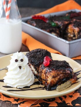 Two Chocolate Sticky Buns with gummy worms and a whipped cream ghost