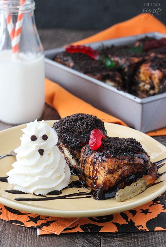 Two Chocolate Sticky Buns with gummy worms and a whipped cream ghost