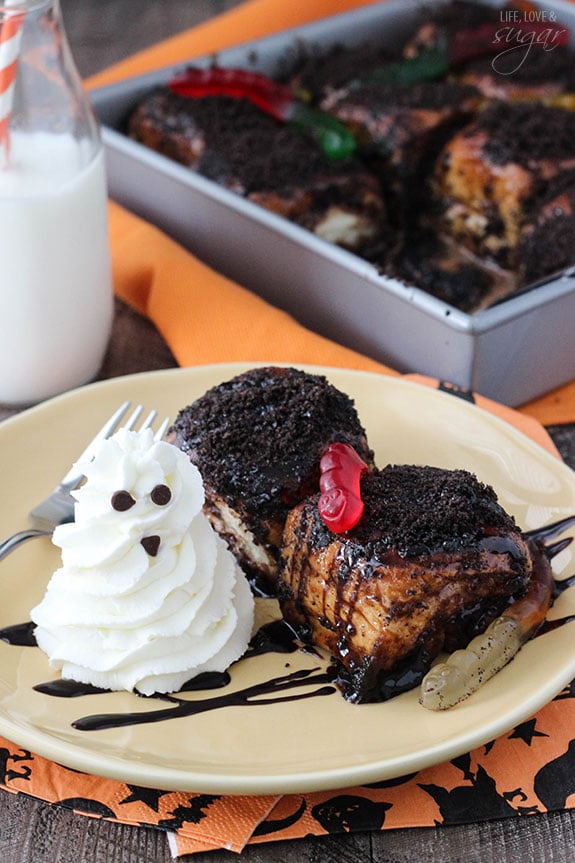 Two Chocolate Sticky Buns with gummy worms and a whipped cream ghost