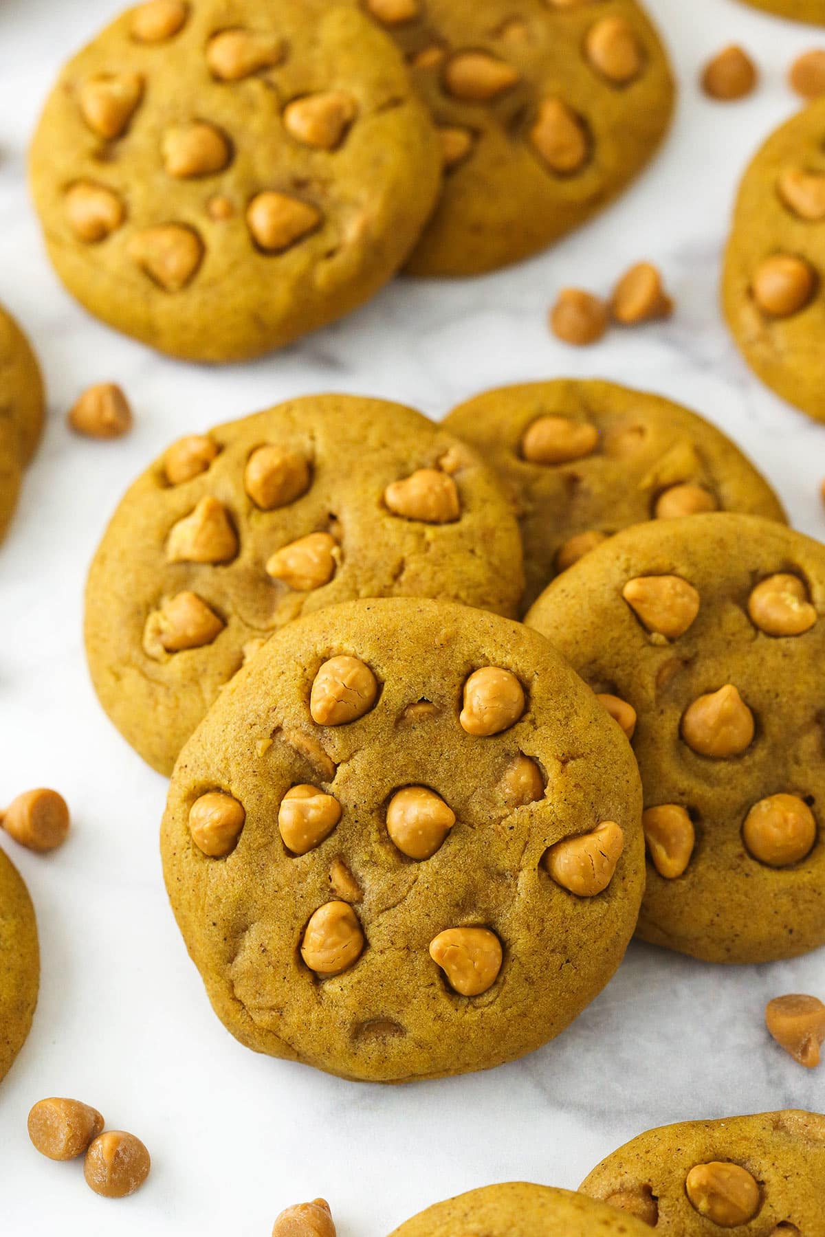 groupings of pumpkin cookies on a marble counter