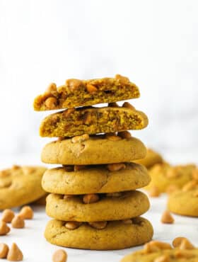 stack of pumpkin butterscotch chip cookies with one broken in half on top