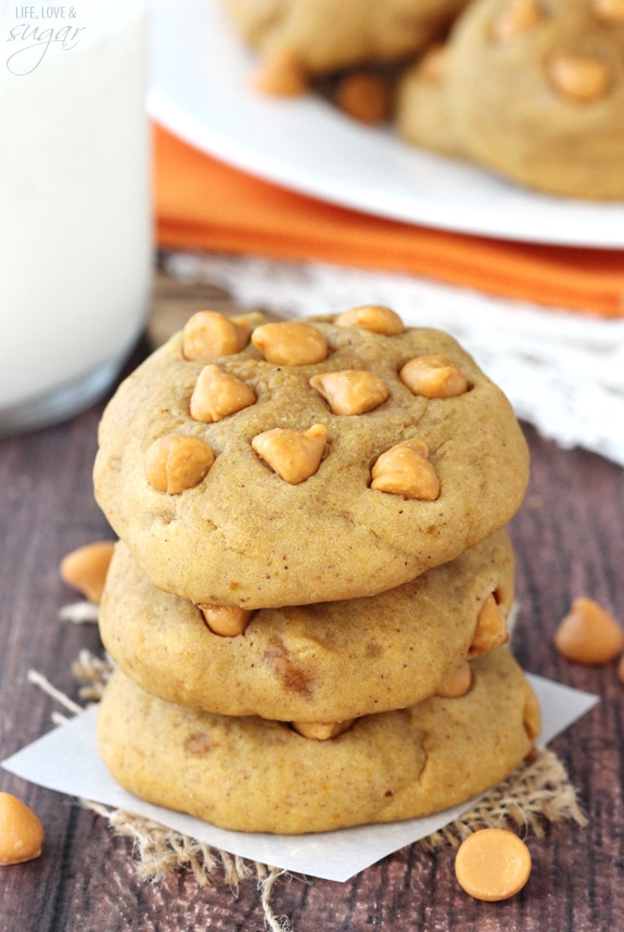 Pumpkin Butterscotch Chip Cookies stacked on a square of parchment paper