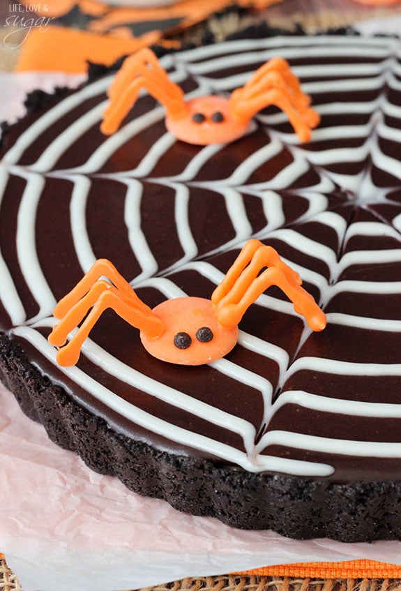 Spiderweb Chocolate Tart with orange candy spiders on top