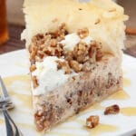 Baklava Cheesecake slice on white plate close up