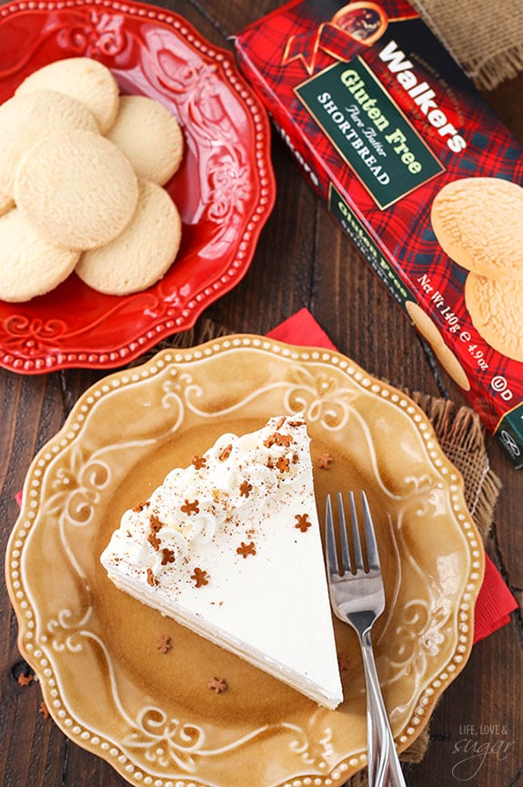 Looking down on a slice of eggnog cake decorated with whipped cream swirls.