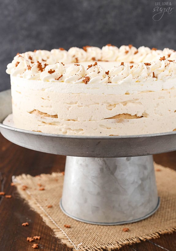 Assembled eggnog icebox cake on a metal stand.