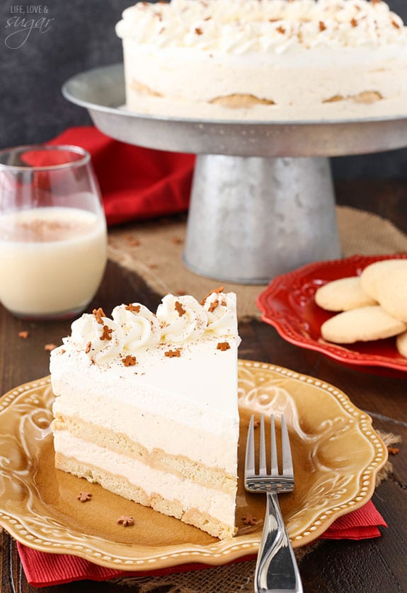 Slice of icebox cake in front of a glass of eggnog.