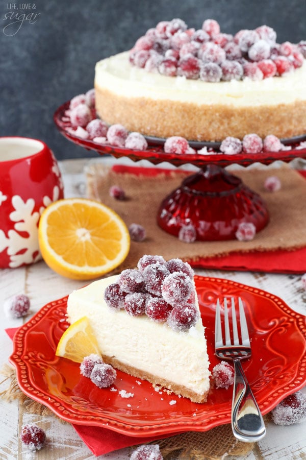 No Bake Sparkling Cranberry Orange Cheesecake slice on a red plate