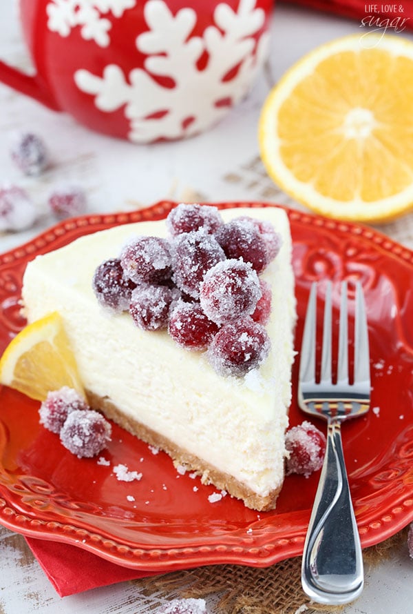 No Bake Sparkling Cranberry Orange Cheesecake slice on a red plate