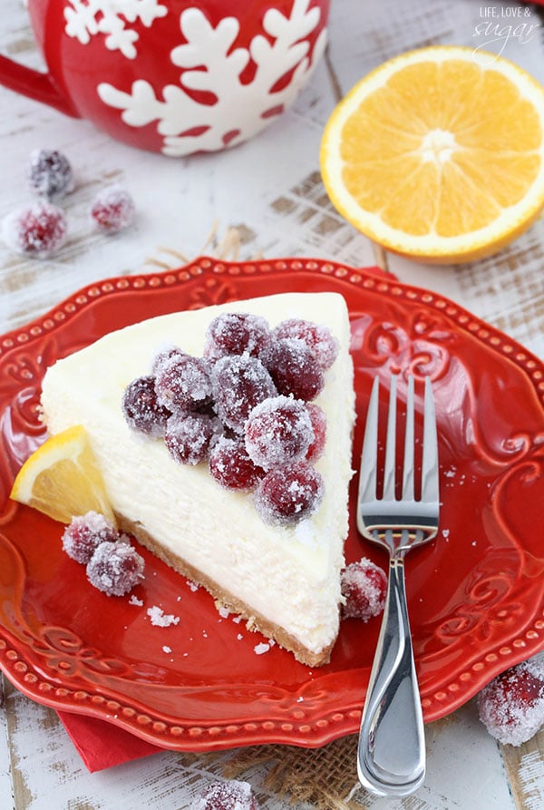 No Bake Sparkling Cranberry Orange Cheesecake slice on a red plate