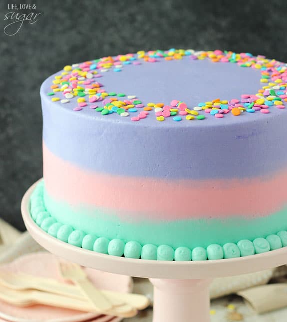 Vanilla Cake with ombre frosting on a cake stand