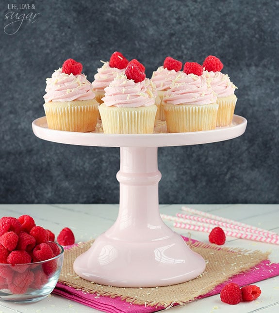 White Chocolate Raspberry Cupcakes on a pink cake stand