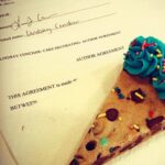 A slice of cookie cake and my authors contract for my new cookbook!