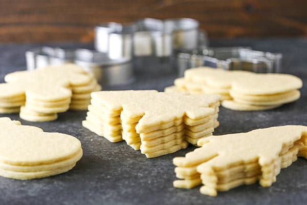 Stacks of holiday sugar cookies in various shapes