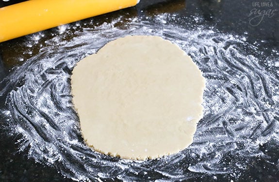 Rolled out sugar cookie dough on floured counter