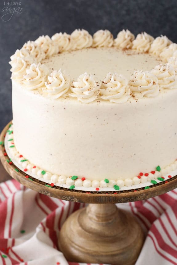 Eggnog layer cake decorated with swirls of frosting.