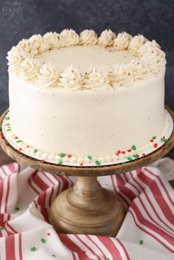 Decorated eggnog layer cake on a cake stand.