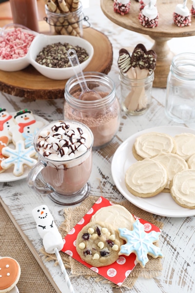 hot chocolate bar featuring white chocolate cranberry cookies and maple iced cookies