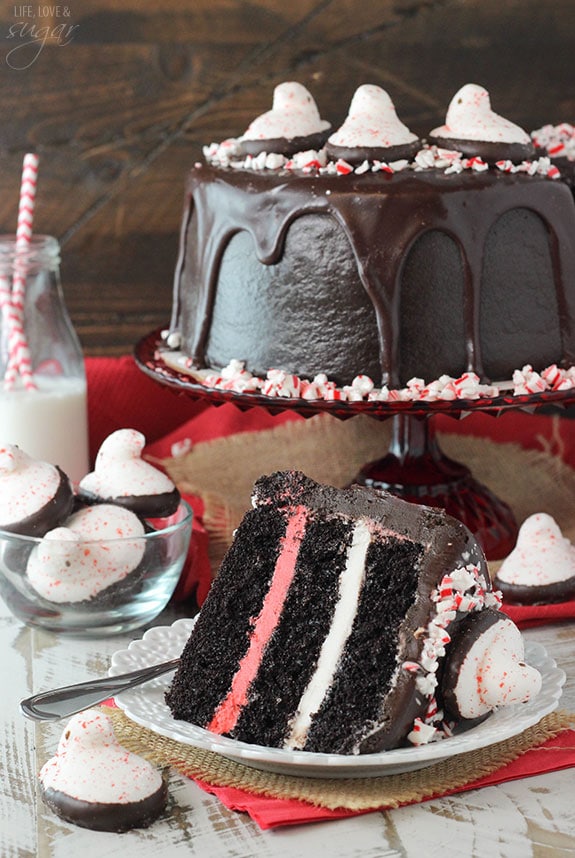 PEEPS® Peppermint Chocolate Cake slice on a plate in front of the whole cake on a cake stand