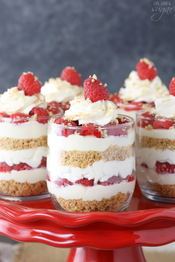 Raspberry Amaretto Cheesecake Trifles on a cake stand