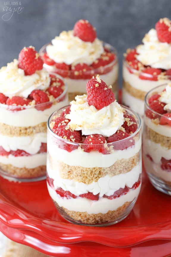 Raspberry Amaretto Cheesecake Trifles on a cake stand