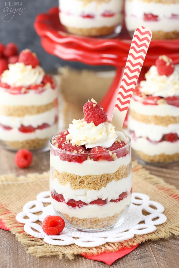 Raspberry Amaretto Cheesecake Trifles in a glass with a spoon