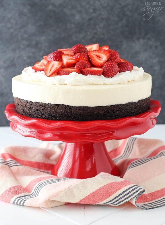 Strawberry Brownie Cheesecake - A moist and chewy brownie topped with no bake vanilla cheesecake, whipped cream and fresh strawberries! Delicious!