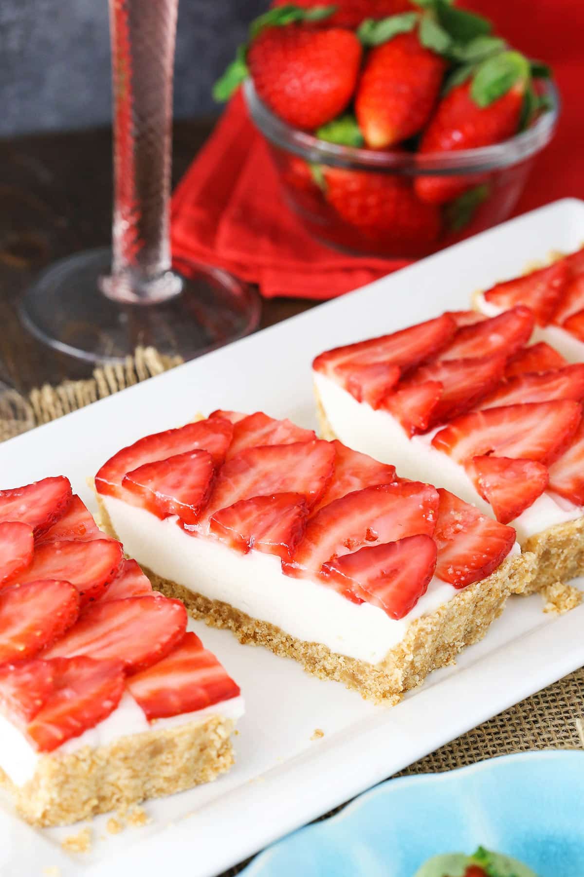 Slices of strawberry champagne tart lined up on a long dessert platter