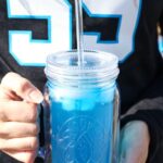 Carolina Panther Punch in front of Panthers jersey